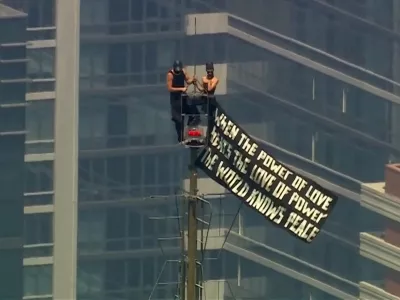 Two people display a banner atop the Empire State Building in the Manhattan borough of New York, U.S., July 1, 2026 in a still image from video. ABC Affiliate WABC/Handout via REUTERS. NO RESALES. NO ARCHIVES. THIS IMAGE HAS BEEN SUPPLIED BY A THIRD PARTY