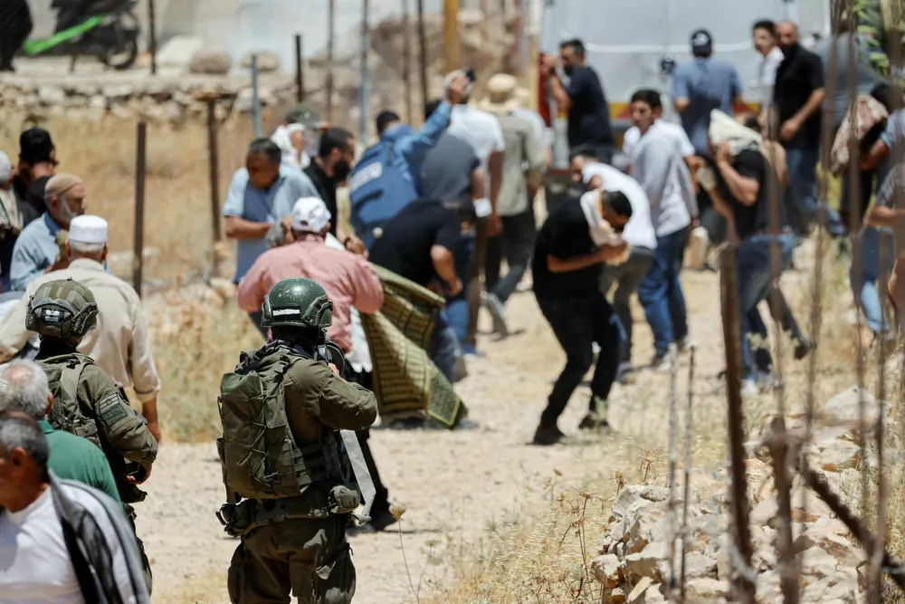 An Israeli soldier uses tear gas against Palestinians as they hold Friday prayers during a protest against Israeli settlement expansion and land confiscation near Bethlehem in the Israeli-occupied West Bank, July 3, 2026. REUTERS/Mussa Qawasma