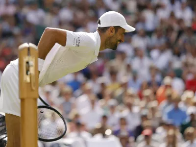 Tennis - Wimbledon - All England Lawn Tennis and Croquet Club, London, Britain - July 3, 2026 Serbia's Novak Djokovic leans over the net during his third round match against France's Arthur Rinderknech REUTERS/Andrew Couldridge