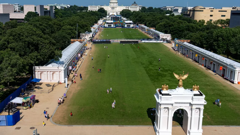 The U.S. Capitol and a model of the United States Triumphal Arch are seen at the Great American State Fair on the National Mall, Thursday, July 2, 2026, in Washington. (AP Photo/Alex Brandon)