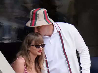 FILE - Taylor Swift gets a kiss from Kansas City Chiefs' Travis Kelce as they arrive to watch the men's singles final of the U.S. Open tennis championships in New York on Sept. 8, 2024. (AP Photo/Frank Franklin II, File)