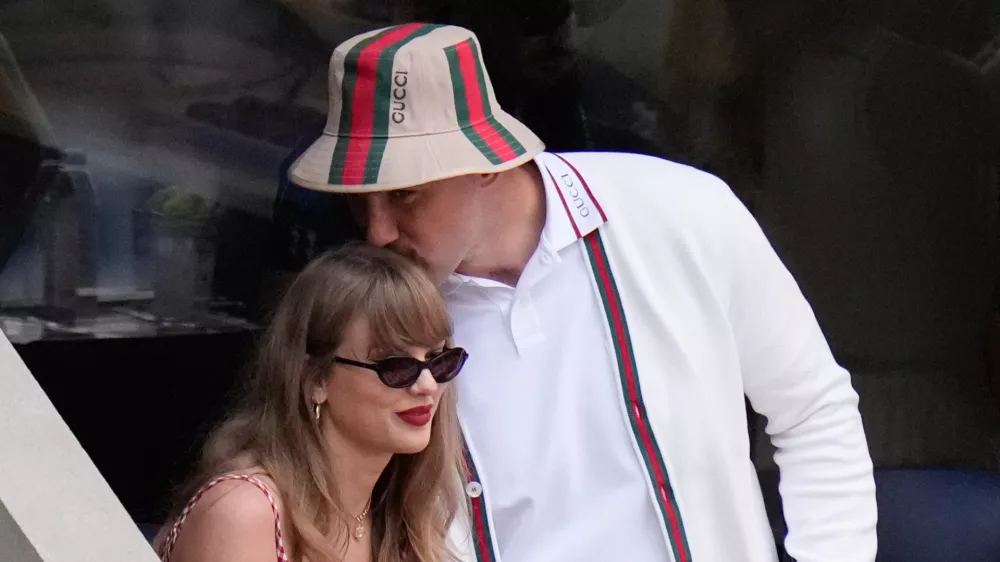 FILE - Taylor Swift gets a kiss from Kansas City Chiefs' Travis Kelce as they arrive to watch the men's singles final of the U.S. Open tennis championships in New York on Sept. 8, 2024. (AP Photo/Frank Franklin II, File)