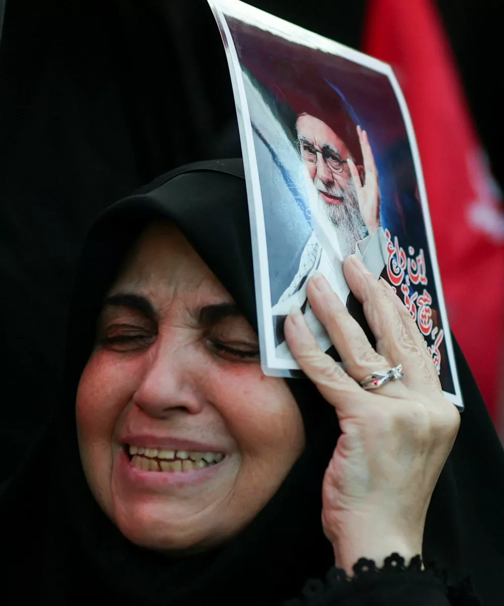 A woman reacts as she holds an image of late Supreme Leader Ayatollah Ali Khamenei, on the day of a public farewell ceremony to pay respects to Khamenei, who was killed on February 28 in Israeli and U.S. airstrikes, at the Imam Khomeini Grand Mosalla, in Tehran, Iran July 4, 2026. REUTERS/Mohammed Salem Foreign media in Iran operate under guidelines set by the Ministry of Culture and Islamic Guidance, which regulates press activity and permissions ISRAEL OUT. NO COMMERCIAL OR EDITORIAL SALES IN ISRAEL. NO ACCESS FOR ISRAELI MEDIA. NO USE BBC PERSIAN. NO USE VOA PERSIAN. NO USE MANOTO. NO USE IRAN INTERNATIONAL. NO USE RADIO FARDA. DIGITAL: NO USE BBC PERSIAN. NO USE VOA PERSIAN. NO USE MANOTO. NO USE IRAN INTERNATIONAL. NO USE RADIO FARDA.