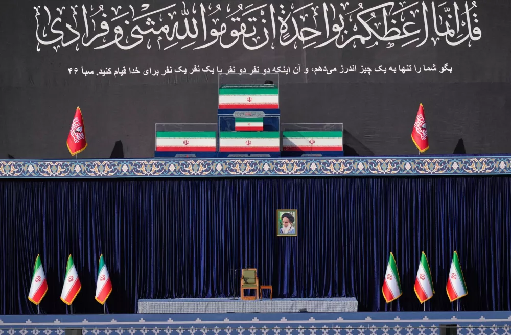 The coffins of slain Iranian Supreme Leader Ayatollah Ali Khamenei and members of his family are displayed on a platform above an empty chair at the start of the dayslong funeral ceremonies at the Imam Khomeini Mosalla Grand Mosque in Tehran, Iran, Saturday, July 4, 2026. (AP Photo/Altaf Qadri)