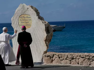 Pope Leo XIV blesses a plaque naming Molo Favaloro after Pope Francis in Lampedusa, Sicily, southern Italy, Saturday, July 4, 2026, during a one-day pastoral visit to the Sicilian island, a frequent landing point for migrants trying to reach Europe. (AP Photo/Alessandra Tarantino)