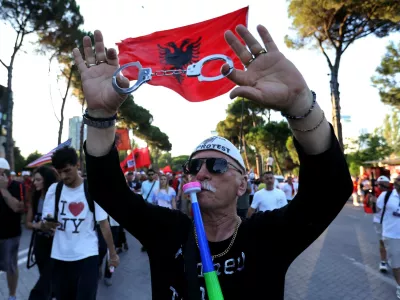 A protester takes part in a rally against plans for a luxury construction project linked to U.S. President Donald Trump's son-in-law, Jared Kushner, in Tirana, Albania, Saturday, July 4, 2026.(AP Photo/Hameraldi Agolli)