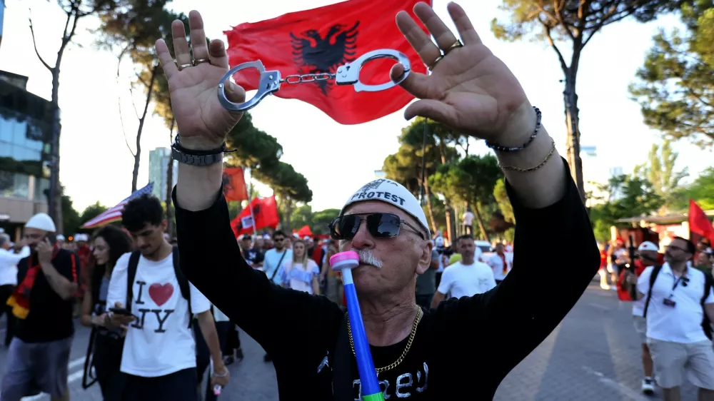 A protester takes part in a rally against plans for a luxury construction project linked to U.S. President Donald Trump's son-in-law, Jared Kushner, in Tirana, Albania, Saturday, July 4, 2026.(AP Photo/Hameraldi Agolli)