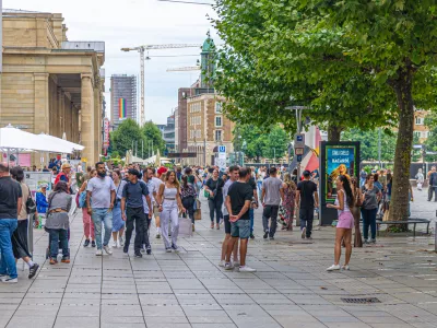 Stuttgart, Germany, July 12, 2024: crowd of people tourists walking down pedestrian street King K&Atilde;&para;nigstra&Atilde;e Koenigstrasse and Castle Square Schlossplatz in old town Stuttgart historic city center