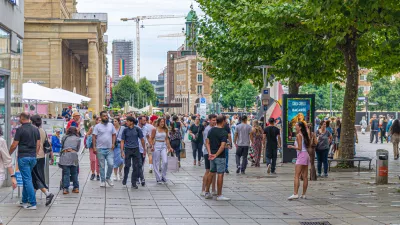 Stuttgart, Germany, July 12, 2024: crowd of people tourists walking down pedestrian street King KÃ¶nigstraÃe Koenigstrasse and Castle Square Schlossplatz in old town Stuttgart historic city center