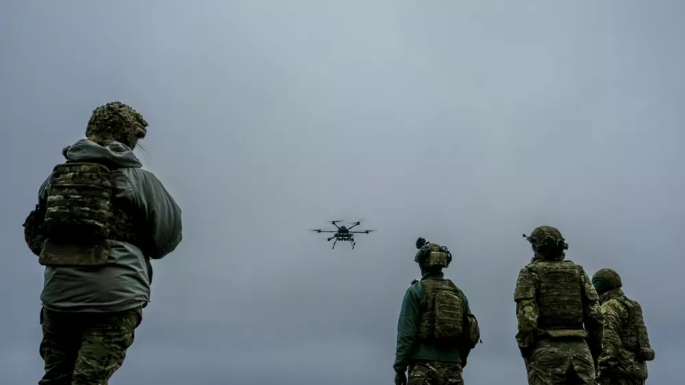 A Ukrainian drone operator from the Kraken 1654 unit, callsign Imla, left, flies a Vampire drone as other soldiers watch, during a demonstration for The Associated Press, Wednesday, Nov. 5, 2025, in Kharkiv Oblast, Ukraine. (AP Photo/Julia Demaree Nikhinson)