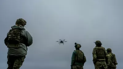 A Ukrainian drone operator from the Kraken 1654 unit, callsign Imla, left, flies a Vampire drone as other soldiers watch, during a demonstration for The Associated Press, Wednesday, Nov. 5, 2025, in Kharkiv Oblast, Ukraine. (AP Photo/Julia Demaree Nikhinson)