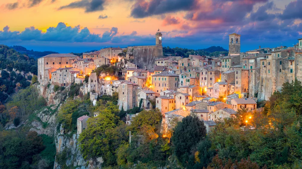 Panoramic view of Sorano in the evening sunset with old tradition buildings and illumination. Old small town in the Province of Grosseto, Tuscany (Toscana), Italy.