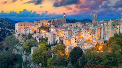 Panoramic view of Sorano in the evening sunset with old tradition buildings and illumination. Old small town in the Province of Grosseto, Tuscany (Toscana), Italy.