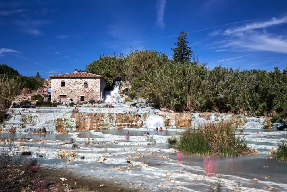 People bathing in the hot water at Terme di Saturnia in Tuscany, Italy