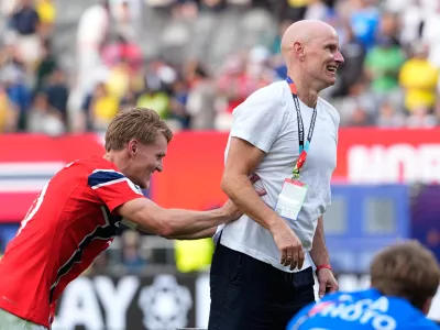 Norway's Martin Oedegaard (10) jokes with Norway head coach Stale Solbakken after the World Cup round of 16 soccer match between Brazil and Norway in East Rutherford, N.J., near New York, Sunday, July 5, 2026. (AP Photo/Frank Franklin II)