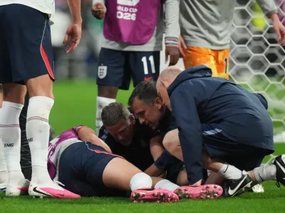 England's Jordan Henderson (14) is looked after by training staff following an injury in the postgame celebration in the World Cup round of 16 soccer match between Mexico and England in Mexico City, Sunday, July 5, 2026. (AP Photo/Eduardo Verdugo)