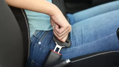 Close up portrait of a driver hand fastening seatbelt in a car