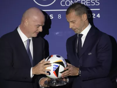 UEFA President Aleksander Ceferin, right, and FIFA President Gianni Infantino pose during the 48th UEFA congress in Paris, Thursday, Feb. 8, 2024. (AP Photo/Christophe Ena)