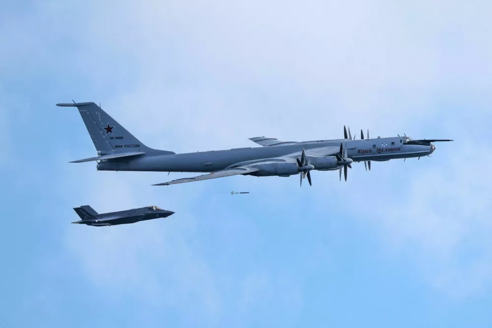 A sonobuoy is deployed from a Russian Tupolev Tu-142 maritime reconnaissance and anti-submarine warfare (ASW) military aircraft by parachute as a British Royal Navy F-35B fighter aircraft flies nearby, northwest of Norway in the Norwegian Sea, July 2, 2026. The British Ministry of Defence said Royal Navy F-35B fighters of the UK Carrier Strike Group launched from HMS Prince of Wales to intercept the Russian aircraft on the afternoon of the 2 July as it transited close to the Strike Group. UK MOD &copy; Crown copyright 2026/PO Phot Chris Sellars/Handout via REUTERS THIS IMAGE HAS BEEN SUPPLIED BY A THIRD PARTY. MANDATORY CREDIT. TPX IMAGES OF THE DAY