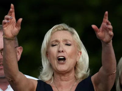 French far-right leader Marine Le Pen, member of parliament for the Rassemblement National (National Rally - RN) party, sings after delivering a speech in front of supporters during a country fair in Lievin, northern France, July 4, 2026. REUTERS/Tom Nicholson