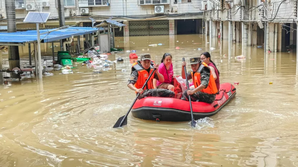 Paramilitary police officers evacuate residents in a rubber dinghy through a flooded area after rainfall brought by typhoon Maysak, in Nanning, Guangxi Zhuang Autonomous Region, China July 6, 2026. cnsphoto via REUTERS  ATTENTION EDITORS - THIS IMAGE WAS PROVIDED BY A THIRD PARTY. CHINA OUT.