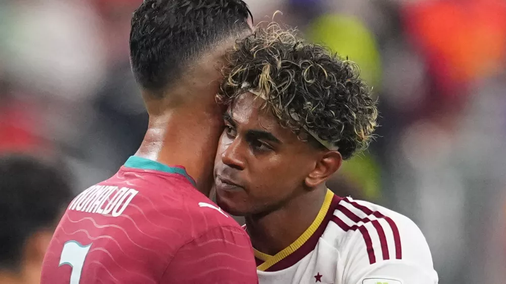Spain's Lamine Yamal, right, hugs Portugal's Cristiano Ronaldo (7) after the World Cup round of 16 soccer match between Portugal and Spain in Arlington, Texas, near Dallas, Monday, July 6, 2026. (AP Photo/Julio Cortez)