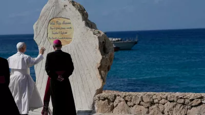 Pope Leo XIV blesses a plaque naming Molo Favaloro after Pope Francis in Lampedusa, Sicily, southern Italy, Saturday, July 4, 2026, during a one-day pastoral visit to the Sicilian island, a frequent landing point for migrants trying to reach Europe. (AP Photo/Alessandra Tarantino)