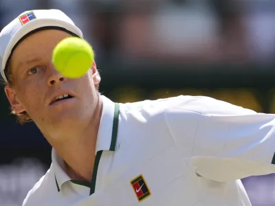 Jannik Sinner of Italy eyes the ball as he prepares to play a forehand against Jan-Lennard Struff of Germany in their quarter-final men's singles match at the Wimbledon Tennis Championships in London, Tuesday, July 7, 2026. (AP Photo/Kin Cheung)