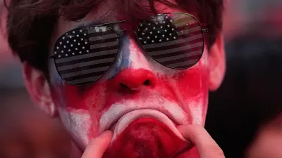 A fan reacts to a United States loss in a World Cup round of 16 soccer match against Belgium at the KC Live! entertainment district Monday, July 6, 2026, in Kansas City, Mo. (AP Photo/Charlie Riedel)