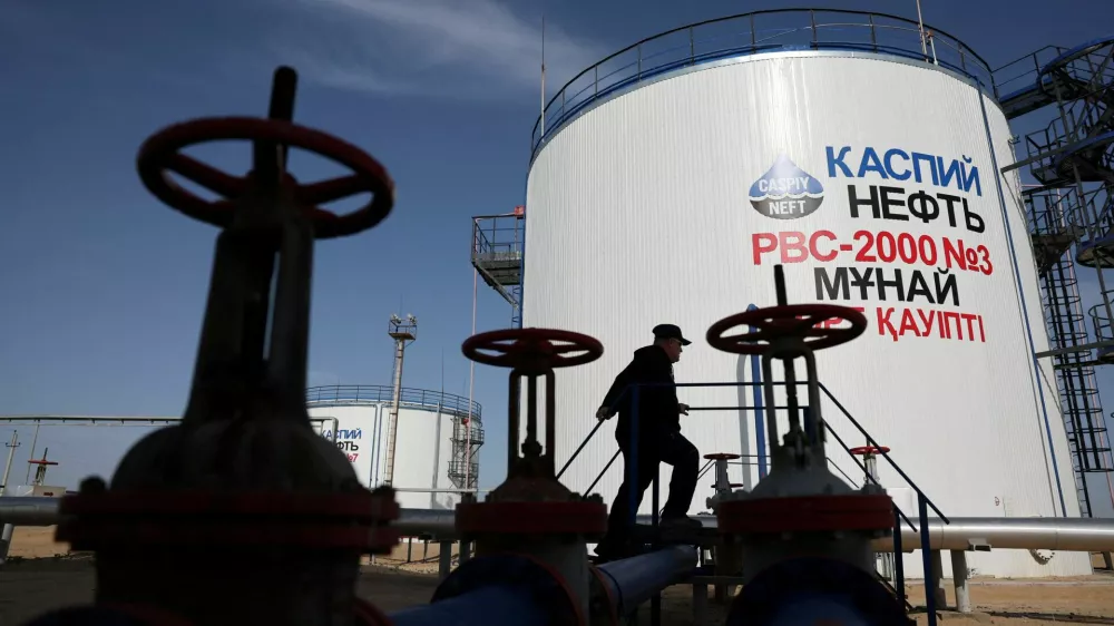 FILE PHOTO: A worker walks near storage tanks at the Airankol oil field operated by Caspiy Neft in the Atyrau region, Kazakhstan, April 20, 2026. REUTERS/Pavel Mikheyev/File Photo