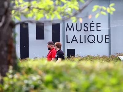 Security members walk past the Musee Lalique, the museum holding works by French luxury glassmaker Rene Lalique, which will remain closed for several days after a theft in which around 20 items of jewellery worth several million euros were stolen on Sunday morning, in Wingen-sur-Moder, eastern France, July 6, 2026. REUTERS/Abdul Saboor