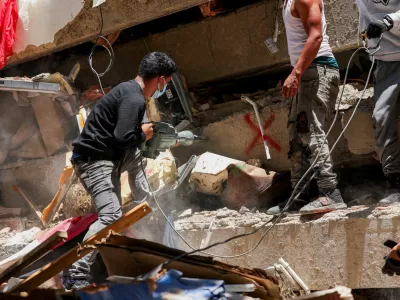 Rescuers work as they help members of Argentina's La Matanza Rescue Team (not pictured) to recover bodies in the Tanaguarena area of Caraballeda, in the aftermath of the deadly June 24 earthquakes, La Guaira state, Venezuela July 7, 2026. REUTERS/Leonardo Fernandez Viloria