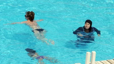 A woman wearing a swimming outfit that covers her body swims at the pool of a hotel in the Tunisian coastal holiday city of Mahdia, on August 31, 2012. According to some local media, fewer women go to the beach wearing bikinis as they fear attacks by religious extremists after the Islamist Ennahda party came to power following the uprising which toppled president Zine el Abidine Ben Ali.,Image: 140650482, License: Rights-managed, Restrictions:, Model Release: no