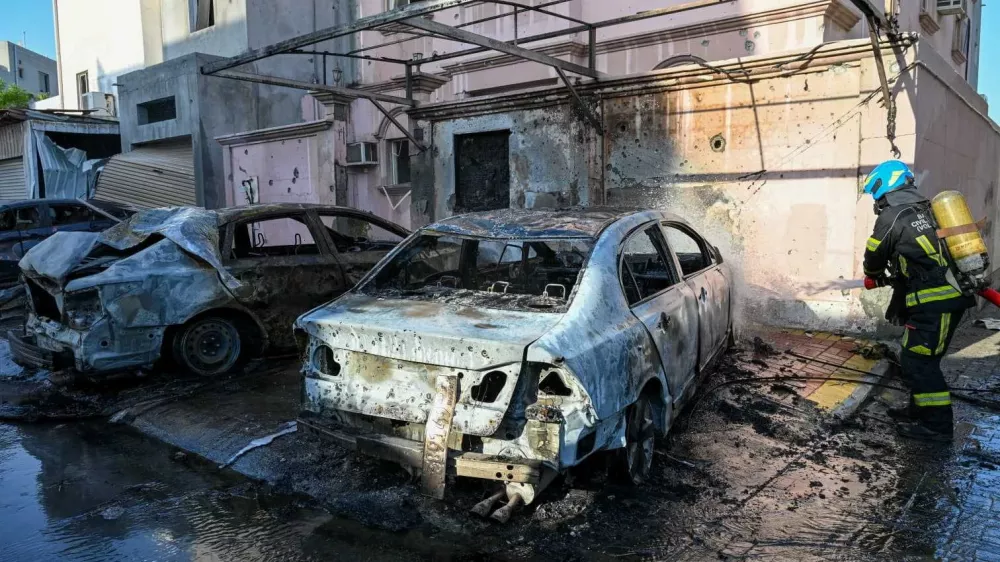 A firefighter works in the aftermath of Iranian drone attacks, according to Bahrain's Interior Ministry, at a location given as Bahrain, in this handout image released on June 11, 2026. Ministry of Interior of the Kingdom of Bahrain/Handout via REUTERS  THIS IMAGE HAS BEEN SUPPLIED BY A THIRD PARTY. VERIFICATION: Location or date not verified. No older version found posted online before June 11. Ministry of Interior of the Kingdom of Bahrain said on X on June 11 that houses and vehicles were damaged due to the falling debris from drone interception.