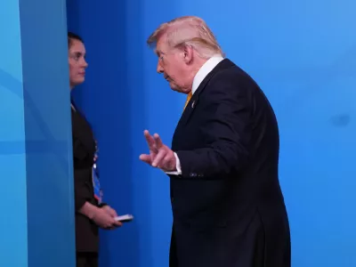 President Donald Trump walks off the podium after a group photo of NATO heads of state and government during the NATO summit in Ankara, Turkey, Wednesday, July 8, 2026. (AP Photo/Francisco Seco)