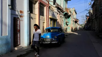 A man walks past a vintage car ahead of an announcement by Cuba's grid operator UNE that it had reconnected most of the country to the national grid, though millions remained without power as the country struggles to generate even one-third of current demand amid an ongoing U.S. fuel blockade, in Havana, Cuba, July 7, 2026. REUTERS/Norlys Perez