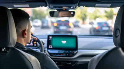 A male driver drives at speed through the streets of the city, a view from inside the car.