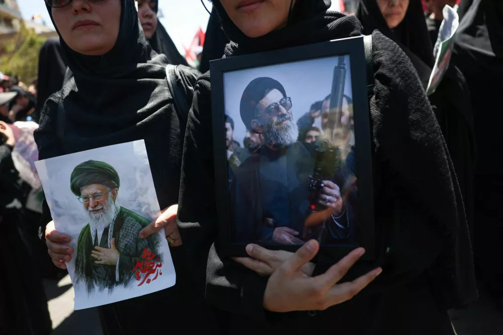 Mourners hold images of Iran's late Supreme Leader Ayatollah Ali Khamenei, who was killed on February 28 in Israeli and U.S. airstrikes, on the day of his burial ceremony in Mashhad, Iran, July 9, 2026. Majid Asgaripour/WANA (West Asia News Agency) via REUTERS  ATTENTION EDITORS - THIS PICTURE WAS PROVIDED BY A THIRD PARTY. ISRAEL OUT. NO COMMERCIAL OR EDITORIAL SALES IN ISRAEL. NO ACCESS FOR ISRAELI MEDIA. NO USE BBC PERSIAN. NO USE VOA PERSIAN. NO USE MANOTO. NO USE IRAN INTERNATIONAL. NO USE RADIO FARDA. DIGITAL: NO USE BBC PERSIAN. NO USE VOA PERSIAN. NO USE MANOTO. NO USE IRAN INTERNATIONAL. NO USE RADIO FARDA