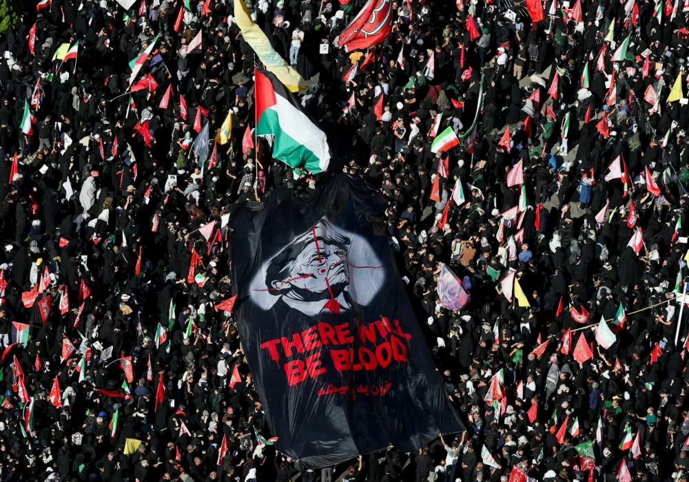 Mourners carry a banner against U.S. President Donald&nbsp;Trump as they gather on the day of the burial of Iran's late Supreme Leader Ayatollah Ali Khamenei, who was killed on February 28 in Israeli and U.S. airstrikes, in a culmination of a mass funeral, in Mashhad, Iran, July 9, 2026. REUTERS/Mohammed Salem Foreign media in Iran operate under guidelines set by the Ministry of Culture and Islamic Guidance, which regulates press activity and permissions.  ISRAEL OUT. NO COMMERCIAL OR EDITORIAL SALES IN ISRAEL. NO ACCESS FOR ISRAELI MEDIA. NO USE BBC PERSIAN. NO USE VOA PERSIAN. NO USE MANOTO. NO USE IRAN INTERNATIONAL. NO USE RADIO FARDA. DIGITAL: NO USE BBC PERSIAN. NO USE VOA PERSIAN. NO USE MANOTO. NO USE IRAN INTERNATIONAL. NO USE RADIO FARDA.