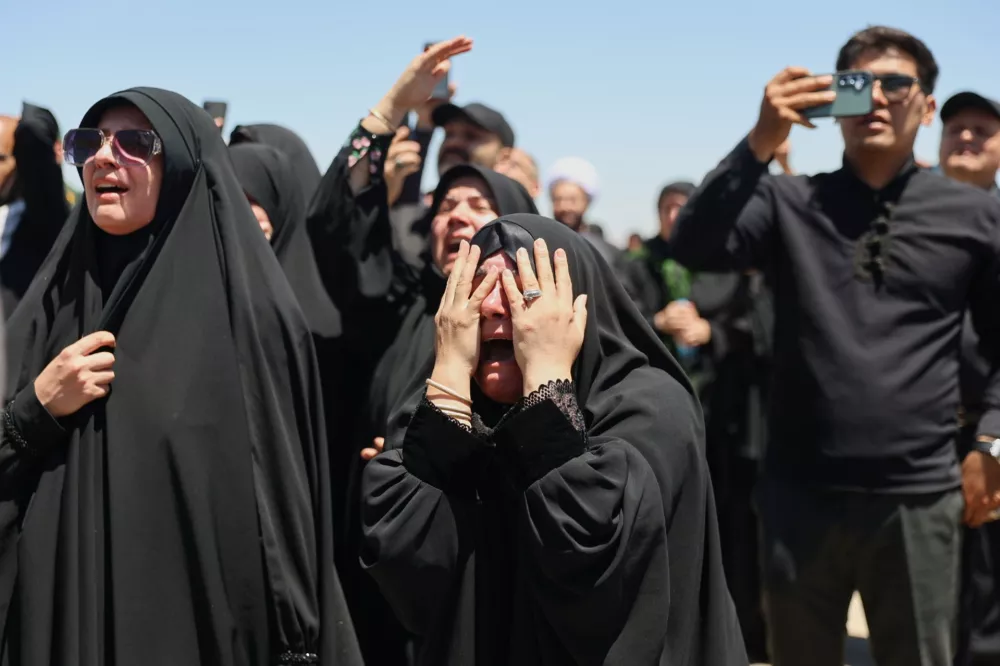 Women react as the coffin of the late Iranian Supreme Leader Ayatollah Ali Khamenei arrives at Hasheminejad International Airport from Iraq for the final stage of his dayslong funeral ceremonies in Mashhad, northeastern Iran, Thursday, July 9, 2026. (Mohammad Hasan Salavati/Shahraranews via AP)
