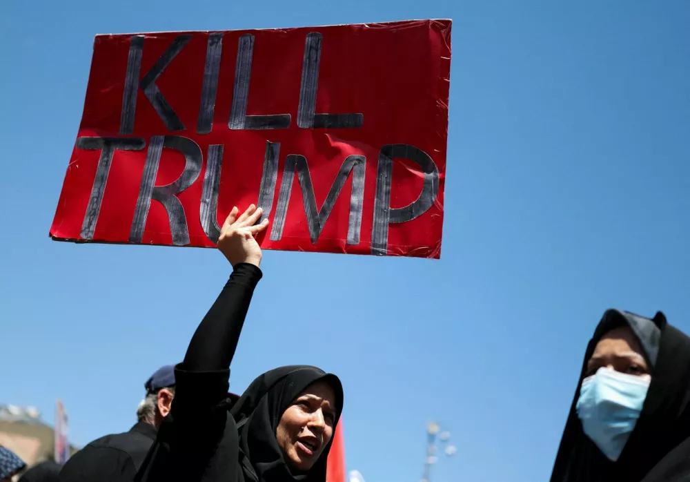 A woman holds an anti-Trump sign as mourners gather during a funeral procession on the day of the burial of Iran's late Supreme Leader Ayatollah Ali Khamenei, who was killed on February 28 in Israeli and U.S. airstrikes, in Mashhad, Iran, July 9, 2026. REUTERS/Mohammed Salem Foreign media in Iran operate under guidelines set by the Ministry of Culture and Islamic Guidance, which regulates press activity and permissions.  ISRAEL OUT. NO COMMERCIAL OR EDITORIAL SALES IN ISRAEL. NO ACCESS FOR ISRAELI MEDIA. NO USE BBC PERSIAN. NO USE VOA PERSIAN. NO USE MANOTO. NO USE IRAN INTERNATIONAL. NO USE RADIO FARDA. DIGITAL: NO USE BBC PERSIAN. NO USE VOA PERSIAN. NO USE MANOTO. NO USE IRAN INTERNATIONAL. NO USE RADIO FARDA.   TPX IMAGES OF THE DAY