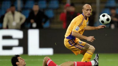 FILE - France's Yoann Gourcuff challenges for the ball with Romania's Gabriel Muresan, right, during their World Cup group 7 qualifying soccer match at Farul Stadium in Constanta, Romania Saturday Oct. 11, 2008. (AP Photo/Francois Mori, File)