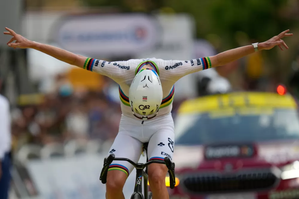 Slovenia's Tadej Pogacar celebrates as he crosses the finish line to win the sixth stage of the Tour de France cycling race with start in Pau and finish in Gavarnie-Gedre, France, Thursday, July 9, 2026. (AP Photo/Mosa'ab Elshamy)