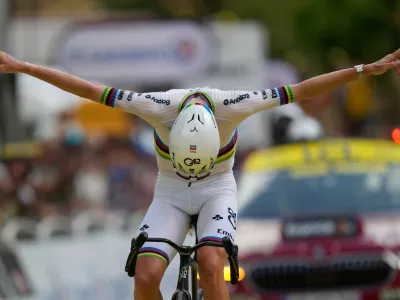 Slovenia's Tadej Pogacar celebrates as he crosses the finish line to win the sixth stage of the Tour de France cycling race with start in Pau and finish in Gavarnie-Gedre, France, Thursday, July 9, 2026. (AP Photo/Mosa'ab Elshamy)