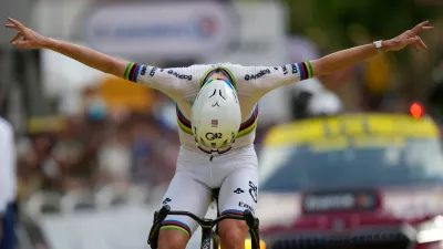 Slovenia's Tadej Pogacar celebrates as he crosses the finish line to win the sixth stage of the Tour de France cycling race with start in Pau and finish in Gavarnie-Gedre, France, Thursday, July 9, 2026. (AP Photo/Mosa'ab Elshamy)
