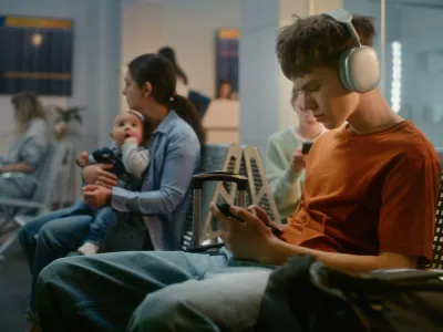 Crowded International Airport Terminal: Teenager in Headphones Using Phone, Woman Sitting with Little Baby. Diverse People and Passengers Waiting for Airplane Flight in Boarding Lounge of Airline Hub.,Image: 997414667, License: Royalty-free, Restrictions:, Model Release: no 