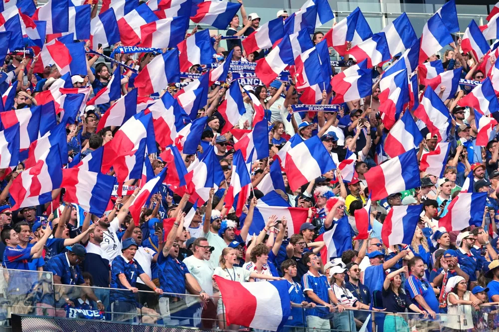 France fans wave flags during the World Cup quarterfinal soccer match between France and Morocco in Foxborough, Mass., near Boston, Thursday, July 9, 2026. (AP Photo/Martin Meissner)