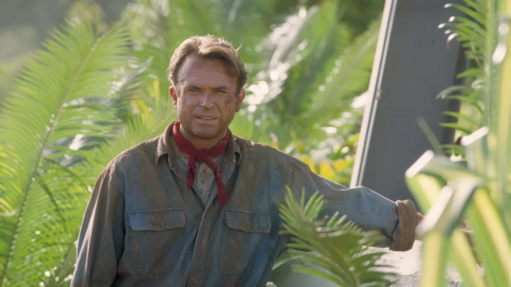 Actor Sam Neill as Dr. Alan Grant, standing next to an electric fence in a scene from the film 'Jurassic Park', 1993. (Photo by Murray Close/Getty Images)