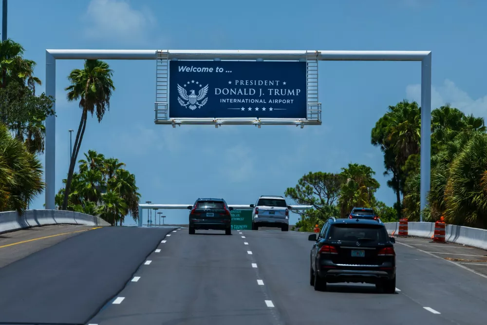 Airport visitors drive under a sign displaying the name of the rebranded Donald J. Trump International Airport in West Palm Beach, Fla., Thursday, July 9, 2026. (AP Photo/Saul Martinez)