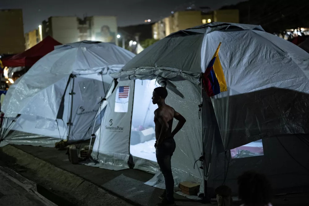 LA GUAIRA, VENEZUELA - JULY 10: A boy stands outside temporary shelters in La Guaira, Venezuela, on July 10, 2026. Residents continue to stay in tents after the powerful 7.2 and 7.5 magnitude earthquakes that struck Venezuela in succession on June 24 caused widespread destruction in the coastal city, forcing thousands of people to leave their homes. Cem Tekkesinoglu / AnadoluNo Use USA No use UK No use Canada No use France No use Japan No use Italy No use Australia No use Spain No use Belgium No use Korea No use South Africa No use Hong Kong No use New Zealand No use Turkey